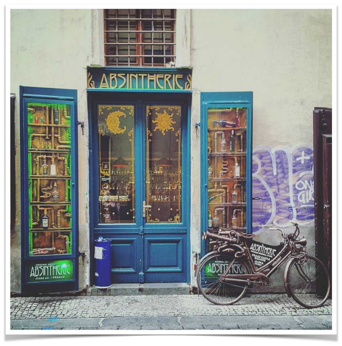 Absinthe bar in Old Town Prague. Art nouveau style. A bicycle is propped against a door.